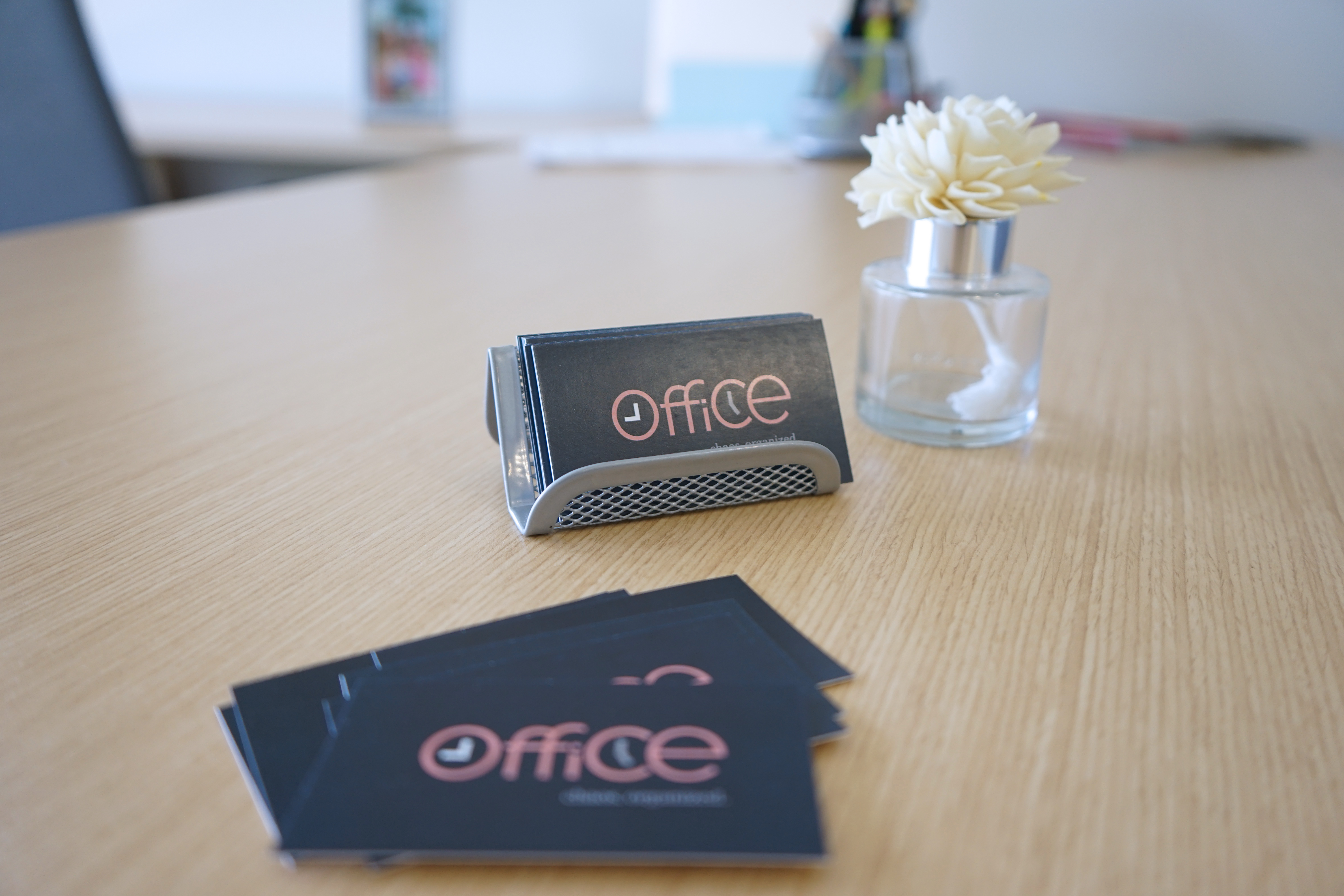 9 to 5 Office branded business cards on a desk.