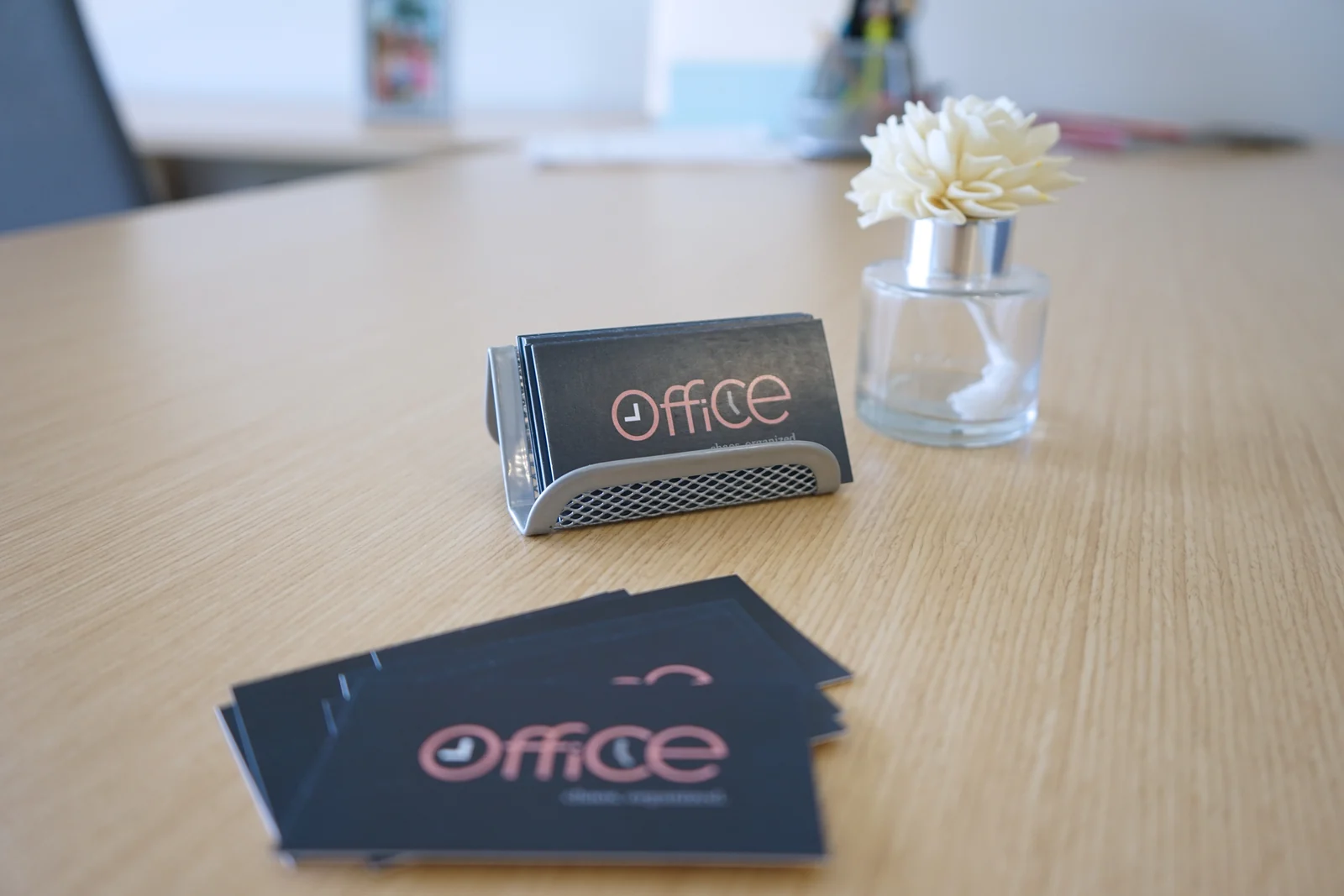 9 to 5 Office branded business cards on a desk.