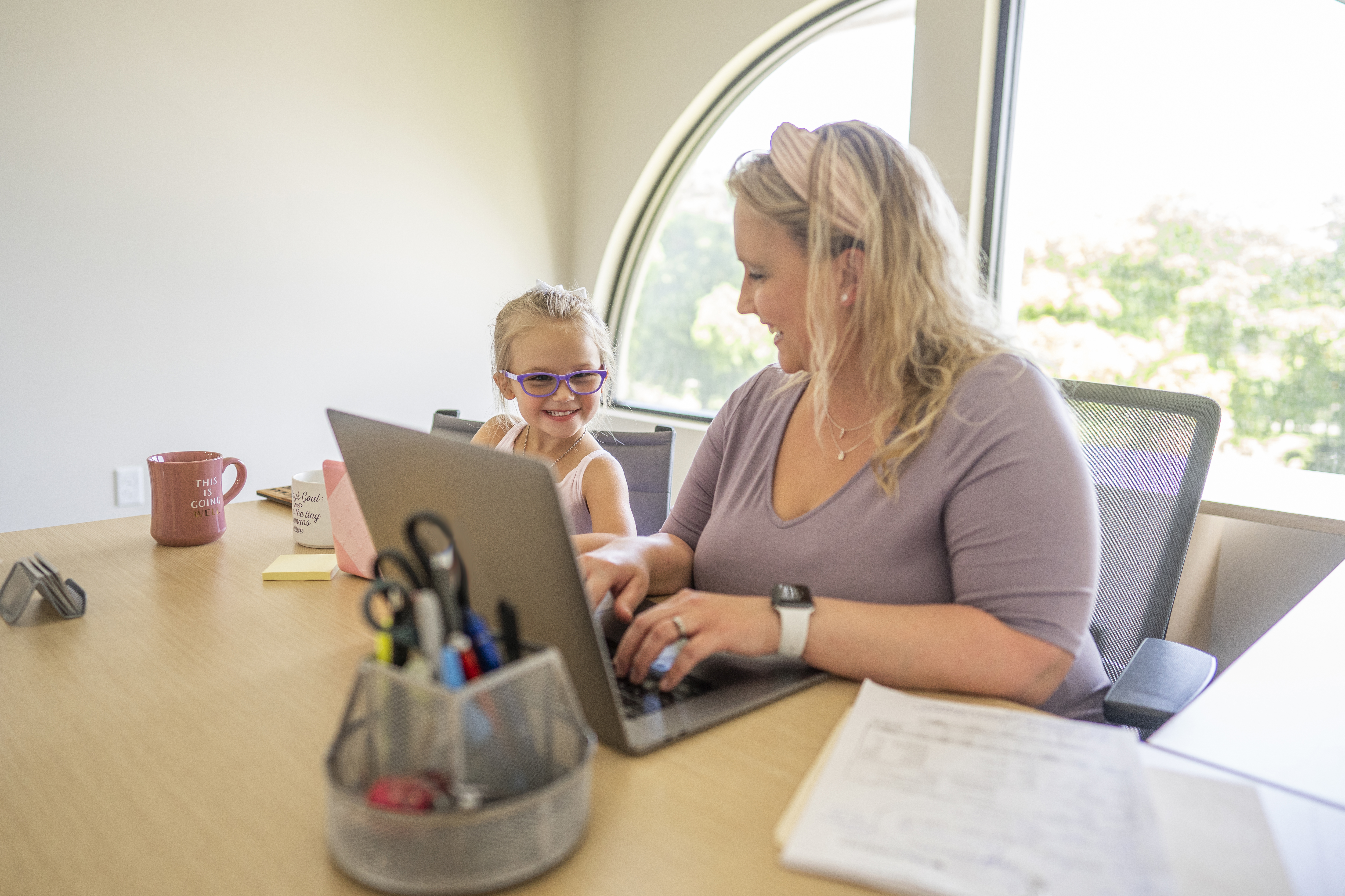 A 9 to 5 Office team member working alongside her young daughter — the family-run practice support behind specialized evaluation practices.