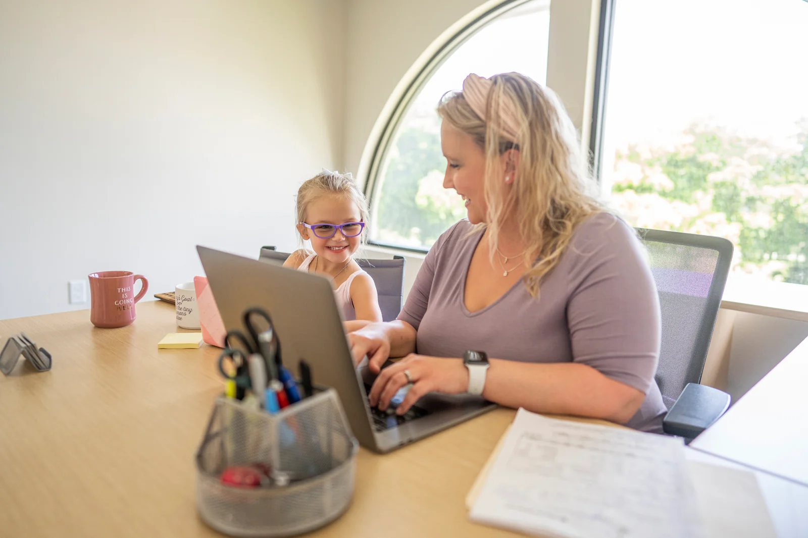 A 9 to 5 Office team member working alongside her young daughter — the family-run practice support behind specialized evaluation practices.