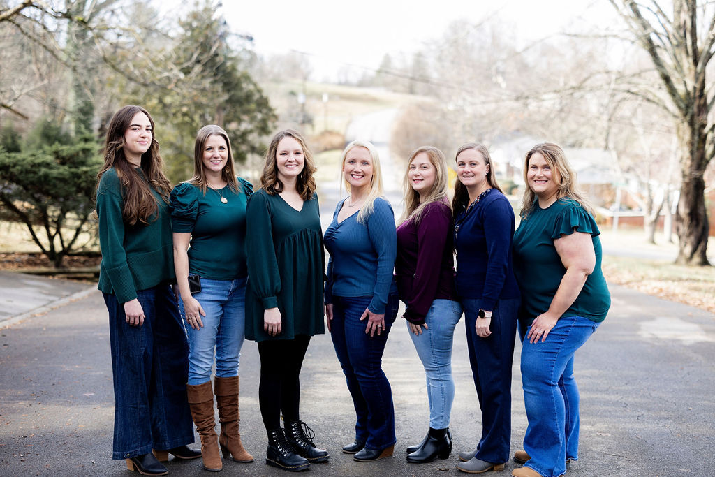 The 9 to 5 Office team standing together outdoors.